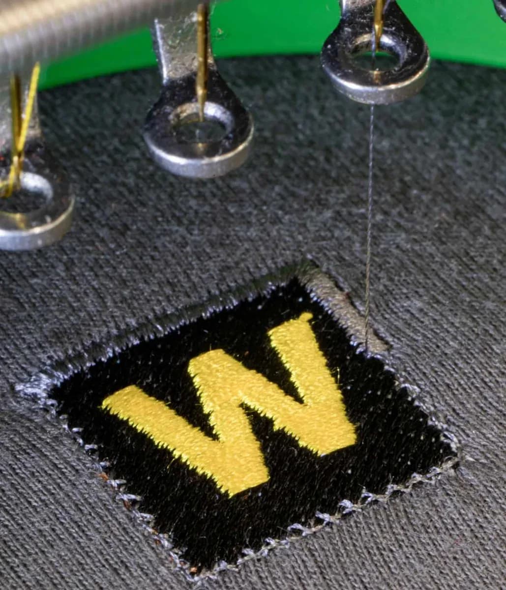 Industrial embroidery machine stitching company logo onto workwear — embroidery Farnborough